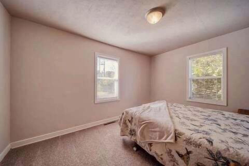Bedroom With Queen Bed, Closet and Television