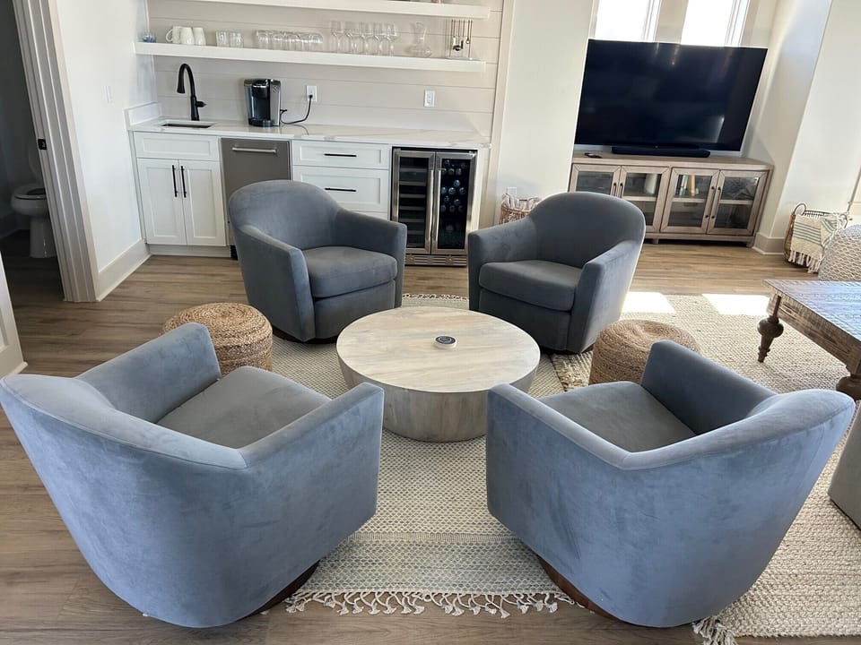 Swivel chair lounge/bar area with wine/beverage fridge, ice maker and sink