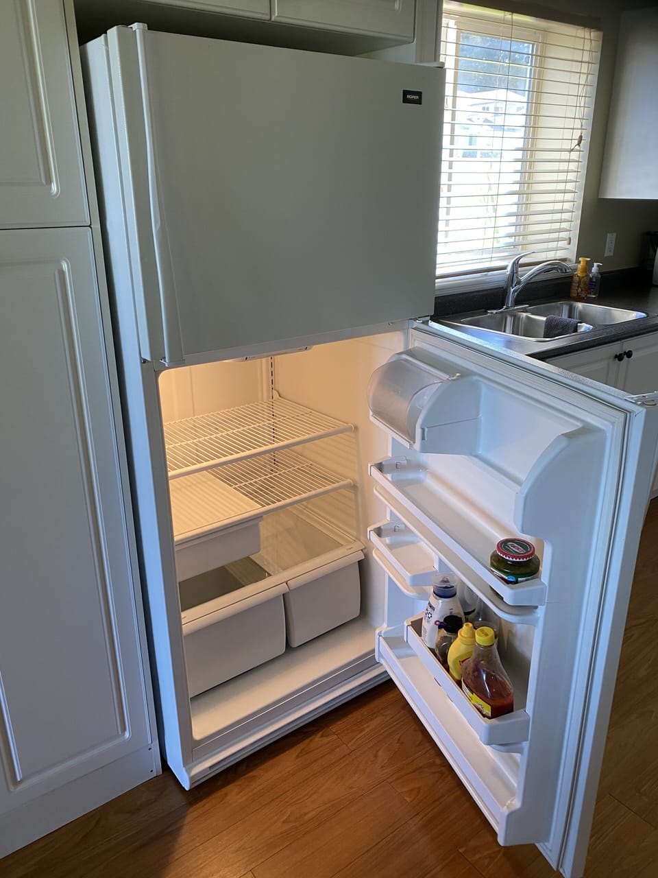 Full size fridge with condiments supplied.