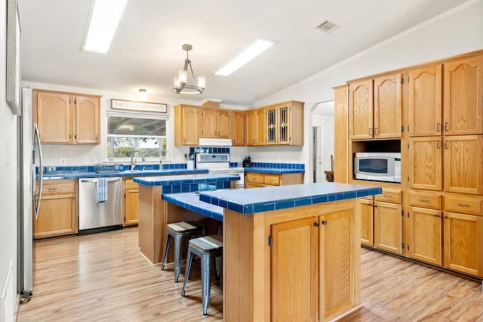 Kitchen with island that four people can sit at to eat.