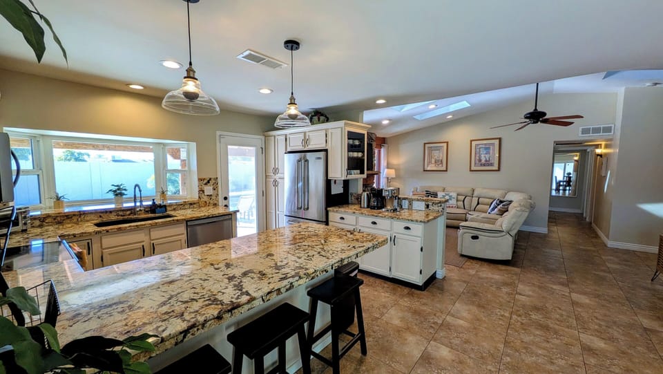 All granite countertops in the open-concept kitchen.