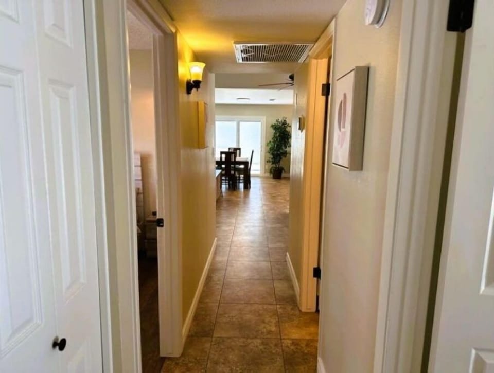 Hallway view past the bedrooms, main bath and into the living/dining area.