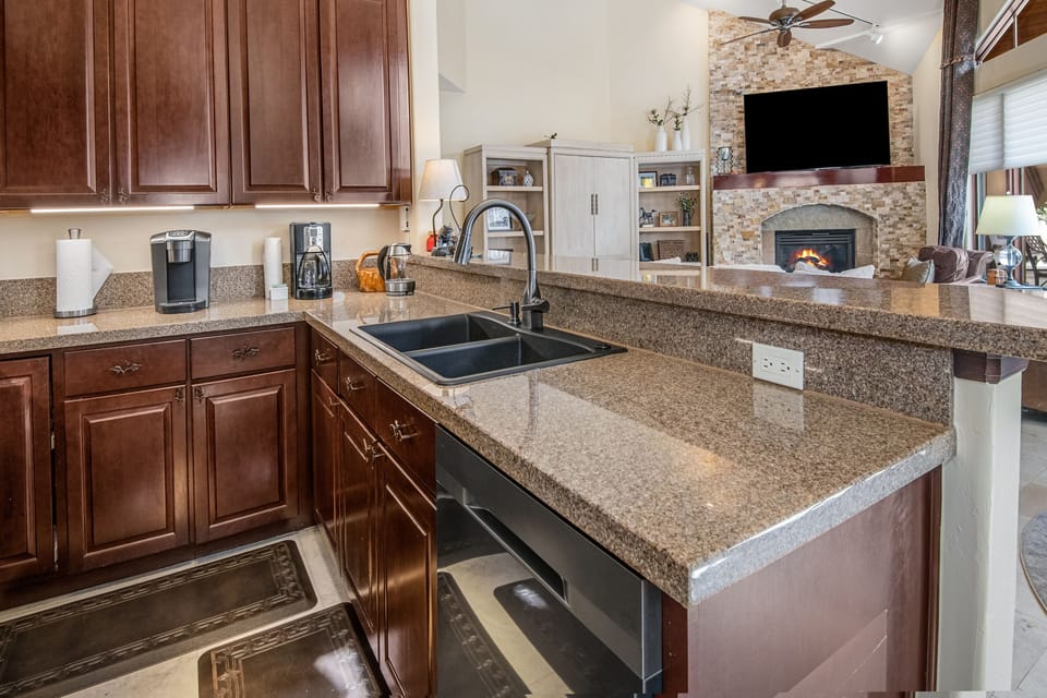 Large fully stocked kitchen with granite counter tops.