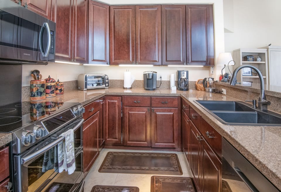 Large fully stocked kitchen with granite counter tops.