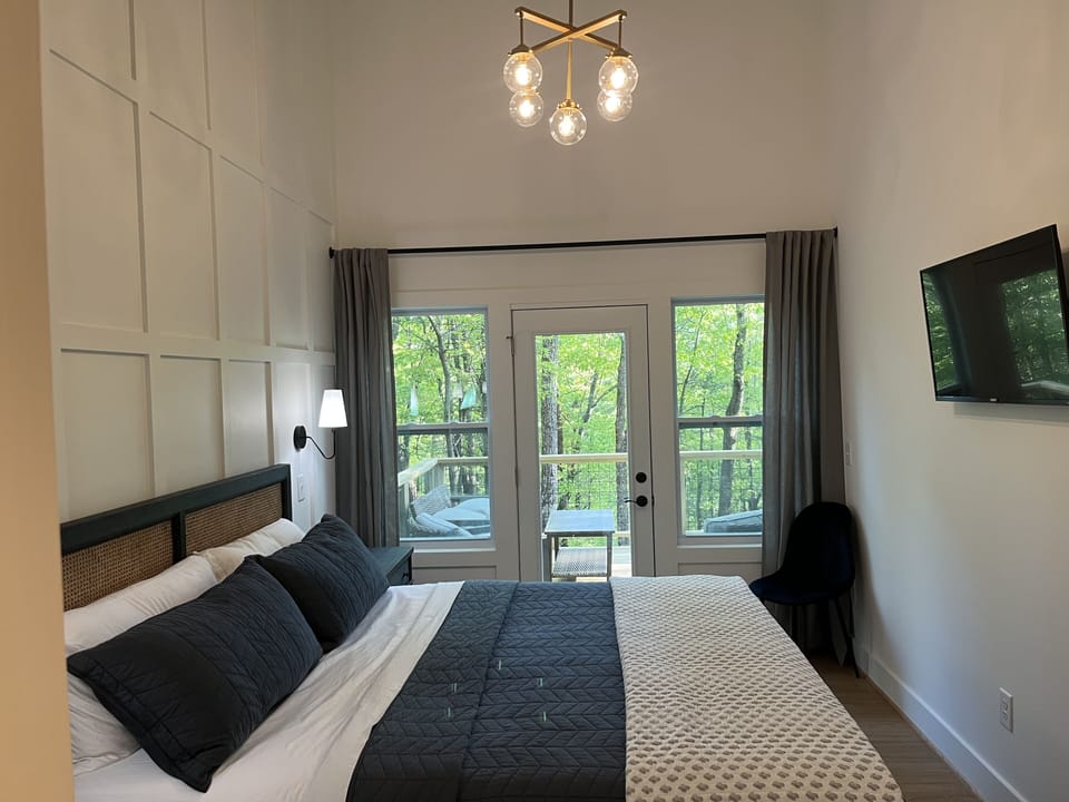 Bedroom 1 with TV and king bed.  It’s own bathroom