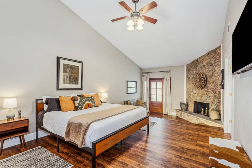 Fabulous primary suite. Take a step down and open the door to access the backyard and pool.