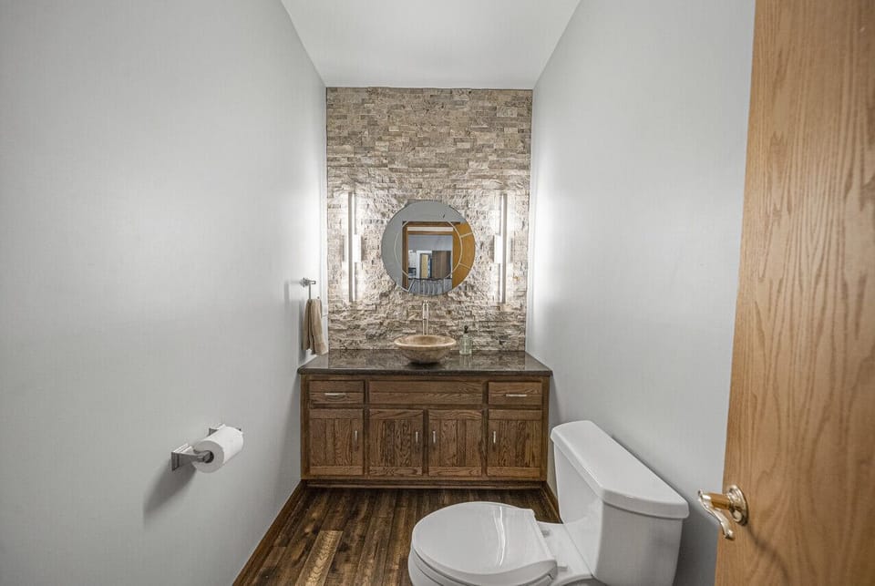 The convenient first floor 1/2 bath provides a luxe spot for guests to refresh
