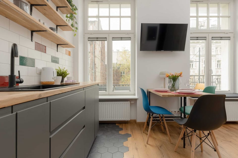 The sleek design of the kitchenette blending seamlessly with the living area.