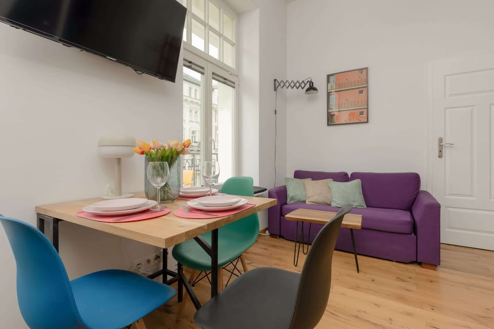 The elegant living room featuring a double sofa bed, perfect for relaxing or sleeping.