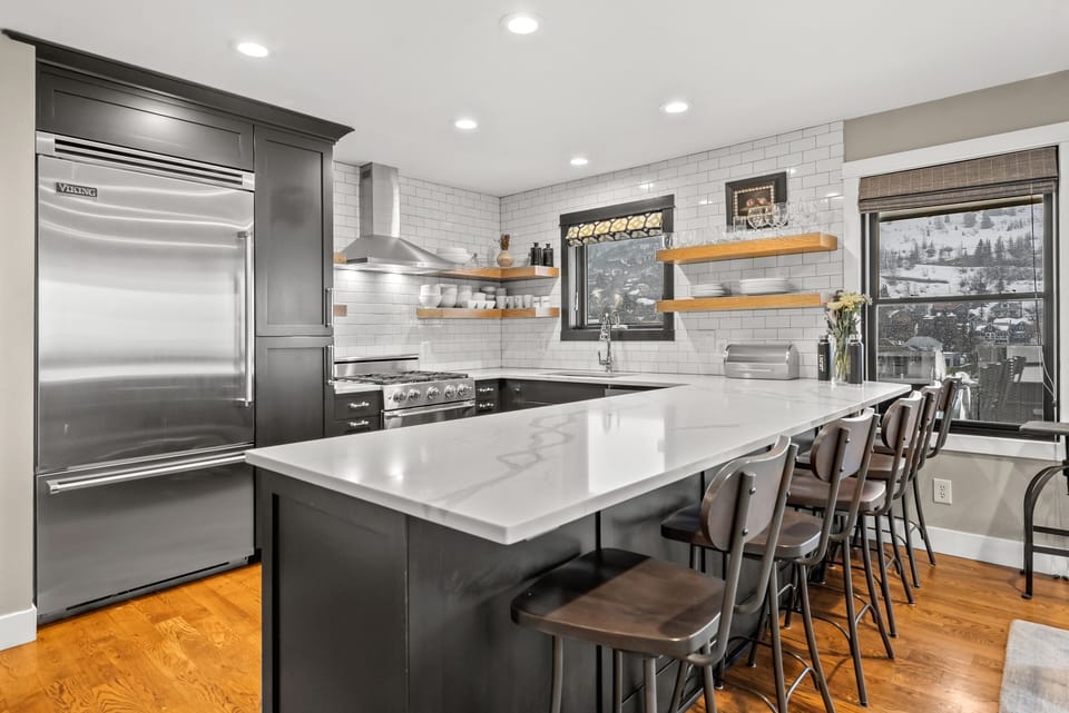 - Modern kitchen with stainless steel Viking appliances  
- Large island seating for meals and entertaining  
- Scenic views from windows while cooking or dining