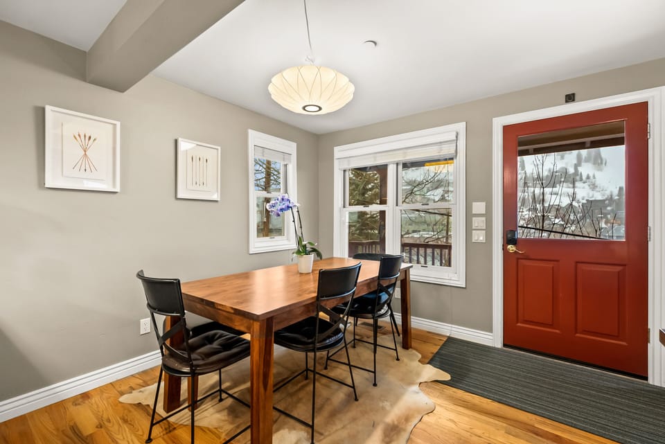 - Dining room with wood table and modern chairs  
- Large windows with mountain town views  
- Perfect for cozy meals and gathering together