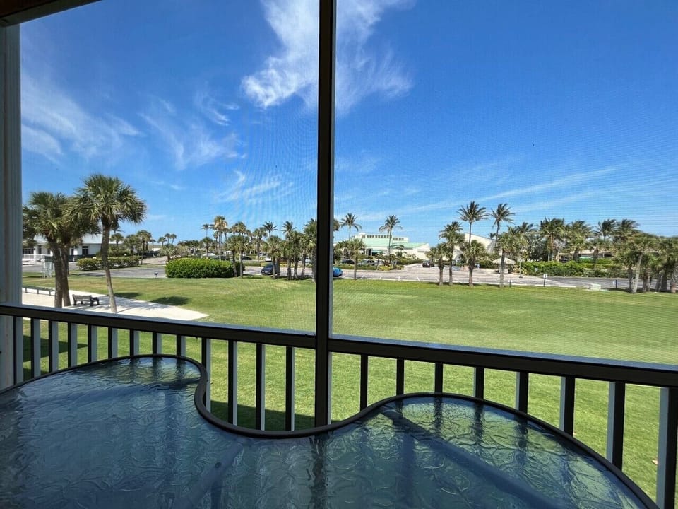 View from Balcony. 1st tee box. Both restaurants across. Beach access far left.