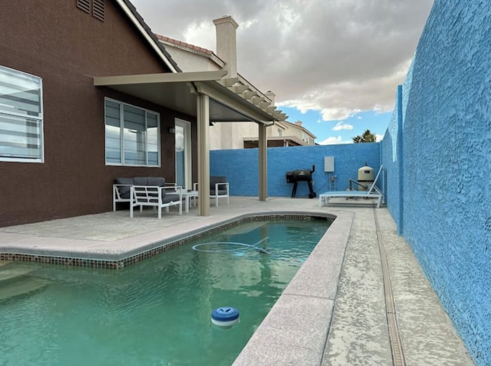 Backyard with pool, seating grill area