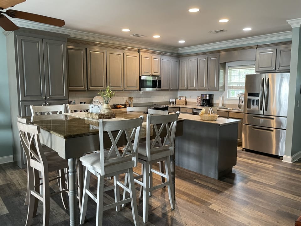 Upstairs open concept kitchen and dining area with seating for 8