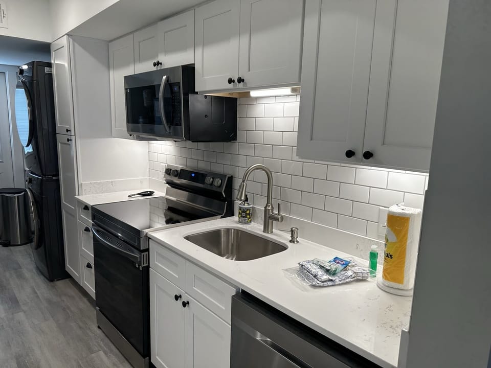 New kitchen- stainless steel appliances with quartz tops- washer/dryer.