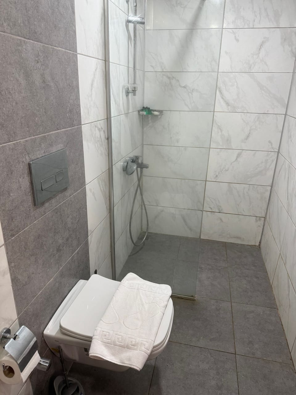 Shower, rainfall showerhead, hair dryer, towels