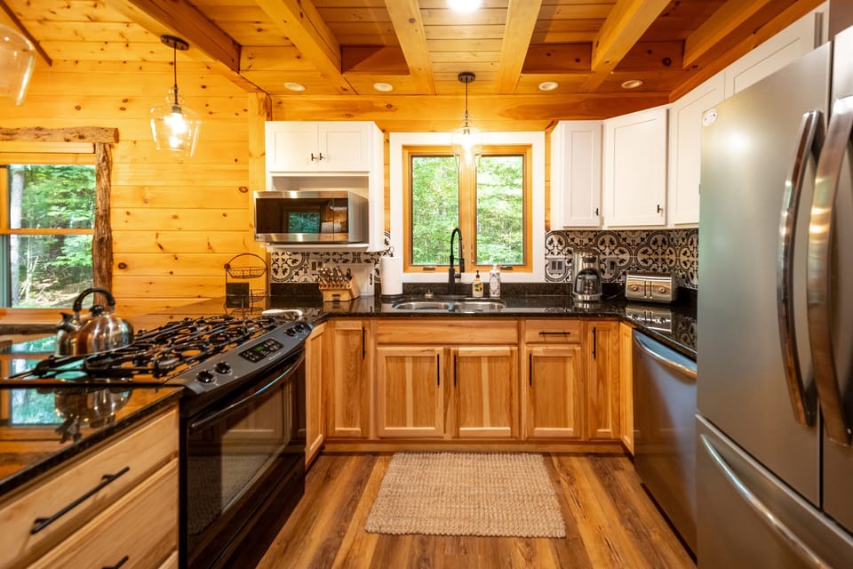The kitchen is fully equipped with stainless appliances and elegant dishware and utensils to prepare great meals at home.