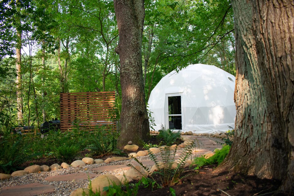 Locally sourced stone pathway leading to dome.