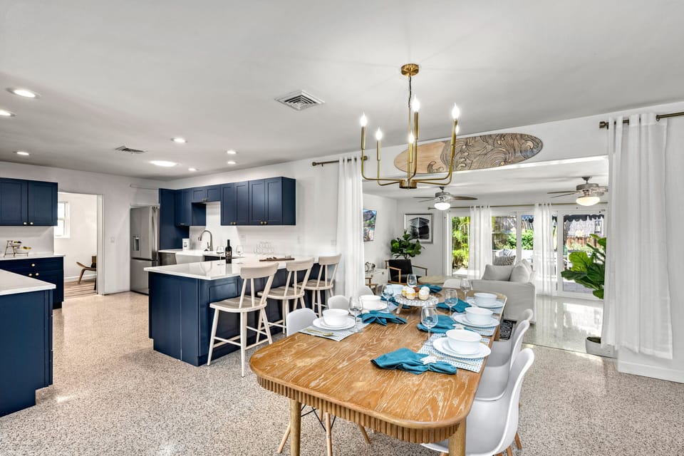 From this angle, see the seamless indoor flow between the dining room, kitchen, and cozy den — the perfect setup for group stays.