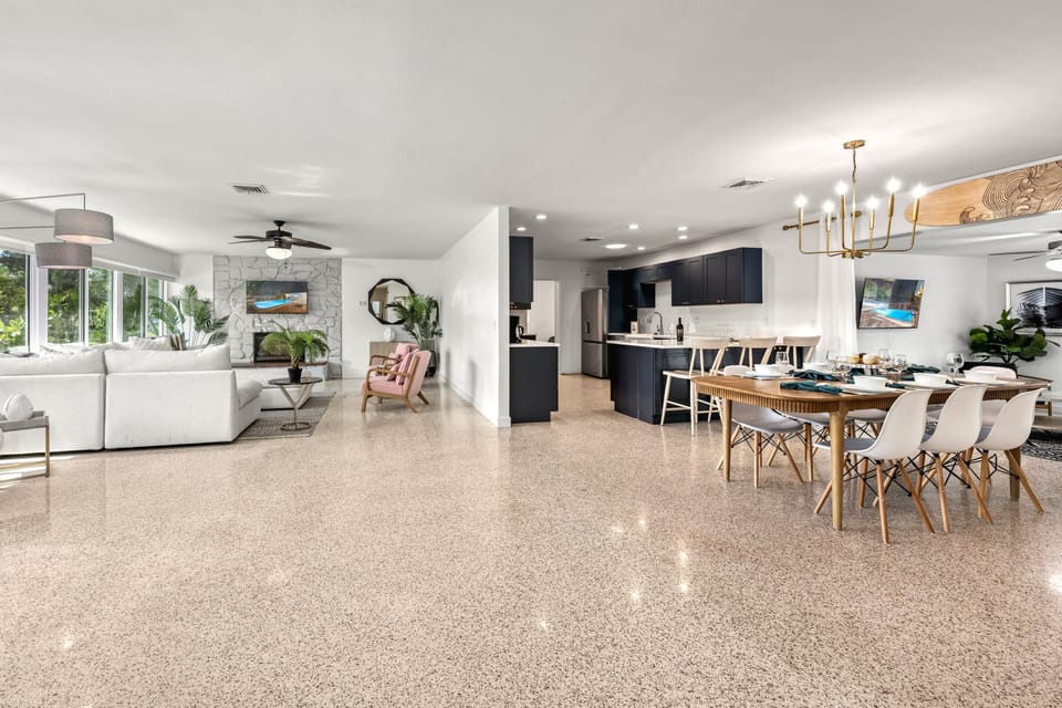 This expansive view captures the full heart of the home — where cooking, dining, and relaxing all come together under one airy roof.