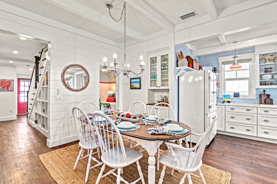Dining with staircase up on left and kitchen on right.