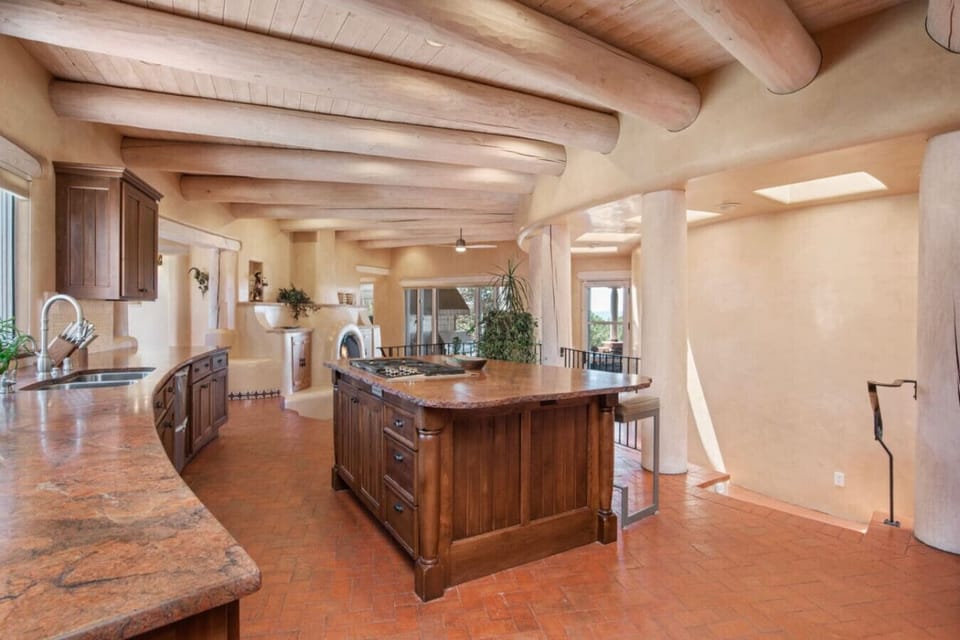 Spacious gourmet kitchen with island, including Wolf gas cooktop and countertop seating