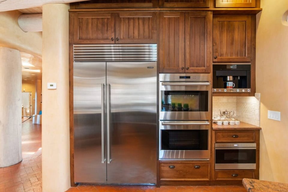 Spacious gourmet kitchen with sub-zero refrigerator, Wolf gas cooktop, double oven, microwave and Miele coffee maker
