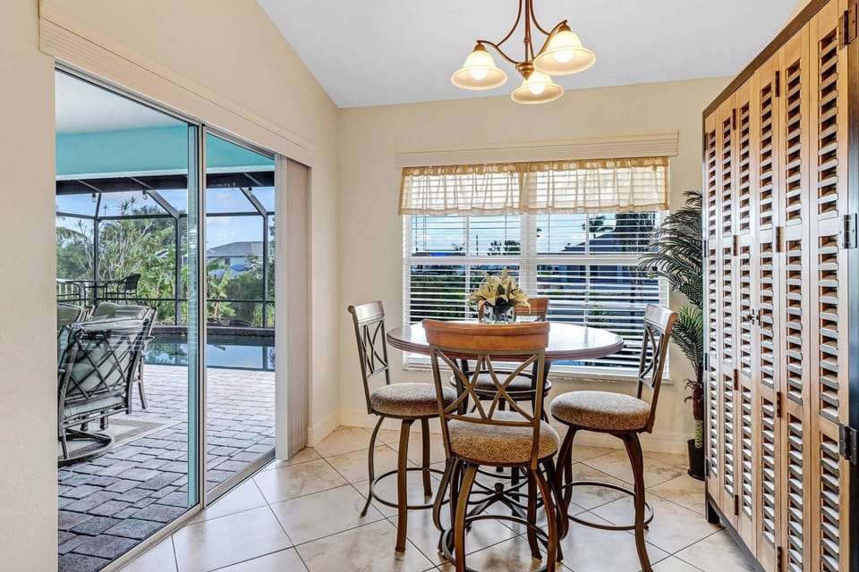 A pub-height table is located in the dining space adjacent to the kitchen, with easy lanai access through sliding glass doors.