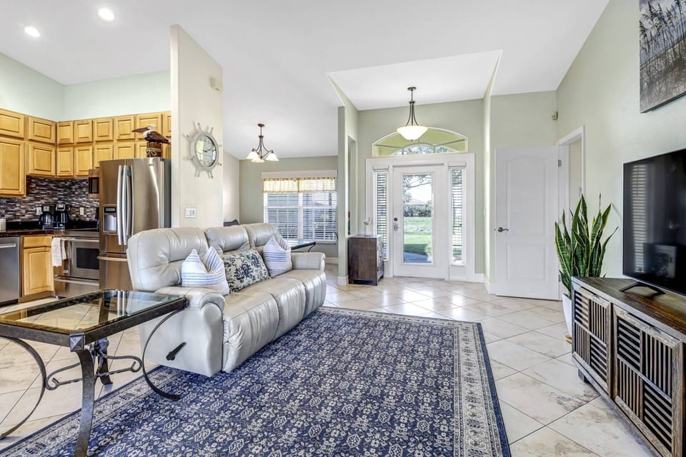 The home is comfortably furnished in a family friendly manner that invites relaxation, including the leather sofa with dual recliners.