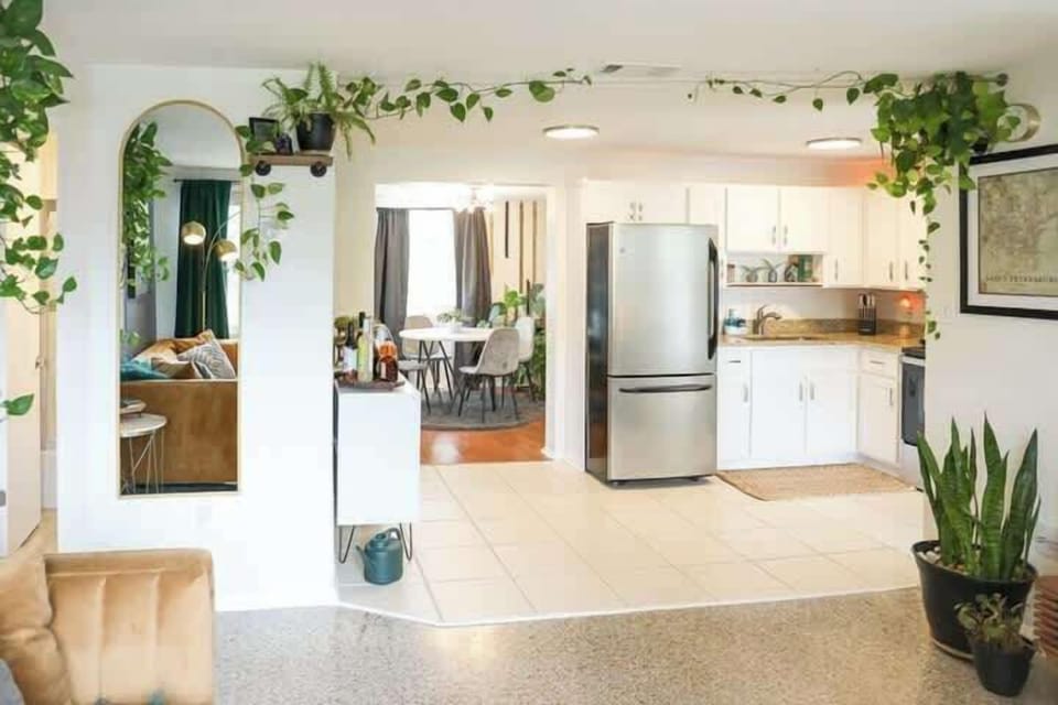 Charming living room, kitchen and dining room area in the back in Mystic Haven vacation rental in Largo, Florida.