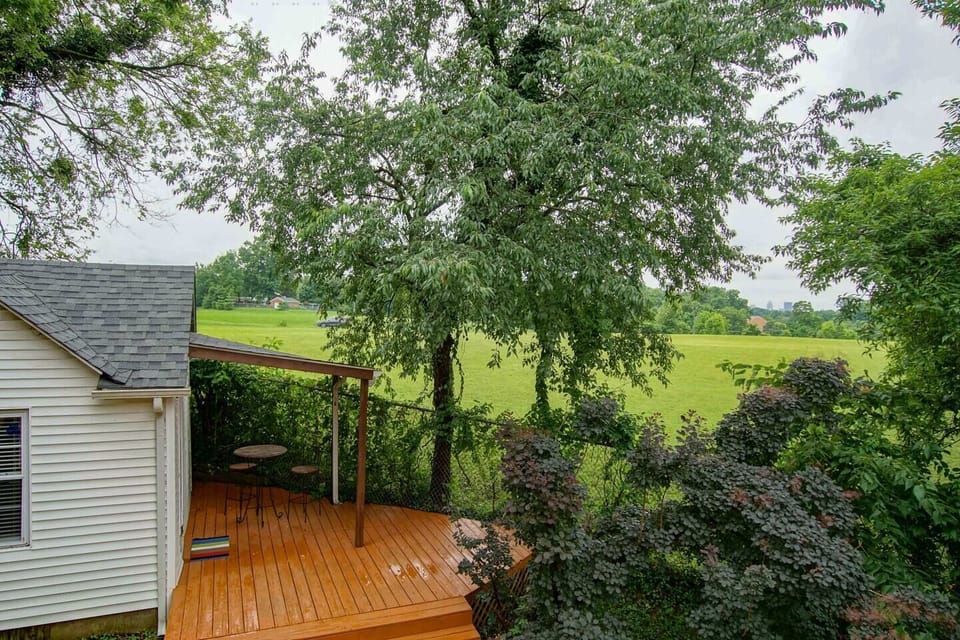View of cottage porch and adjacent field from 2nd floor deck.