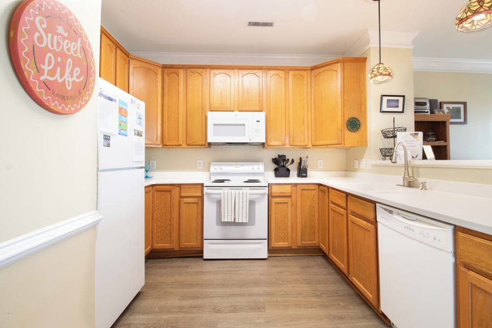 Your fully equipped kitchen features rich wood cabinets, modern appliances, and ample counter space for preparing delicious meals during your stay.