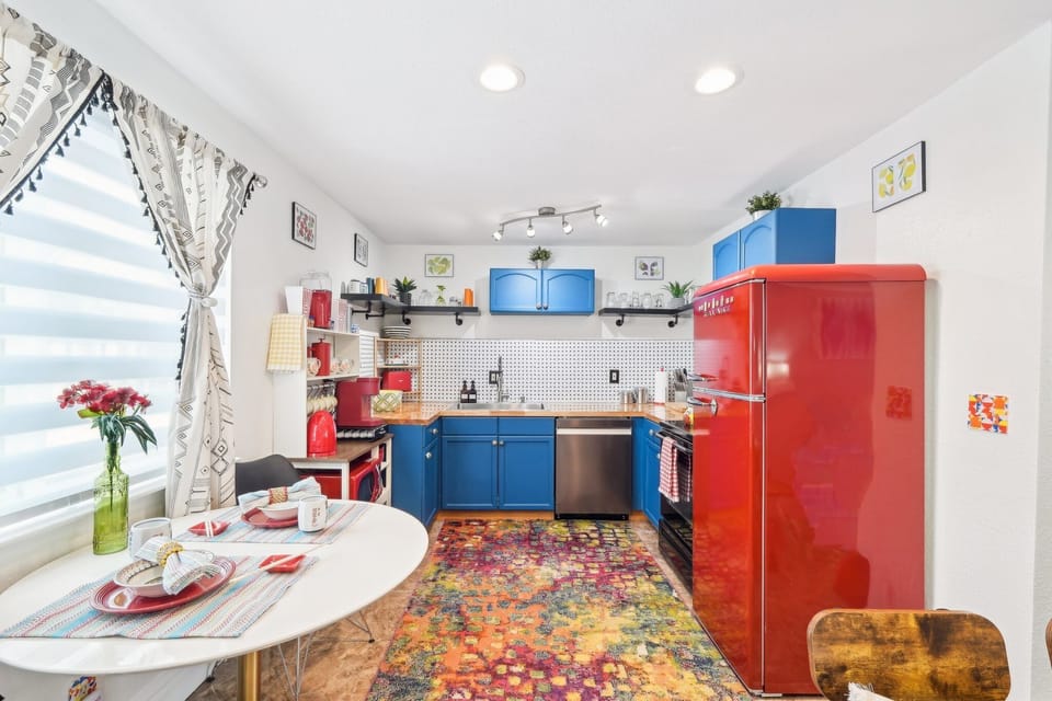 The vibrant retro kitchen is fully equipped for cooking at home.
