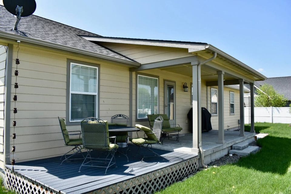 Partially covered back deck with a table and BBQ - perfect for eating outside