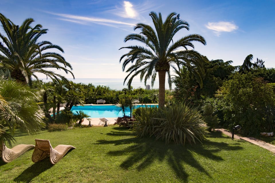 Outdoor pool, a rooftop pool, pool umbrellas, sun loungers