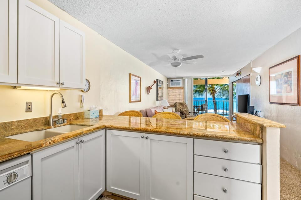 Full kitchen with modern appliances and all utensils provided, ideal for preparing meals before or after your Kona adventures.