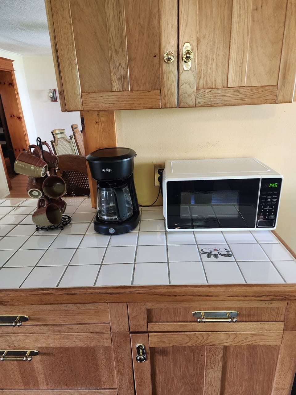 coffee cups, coffee maker, microwave. 