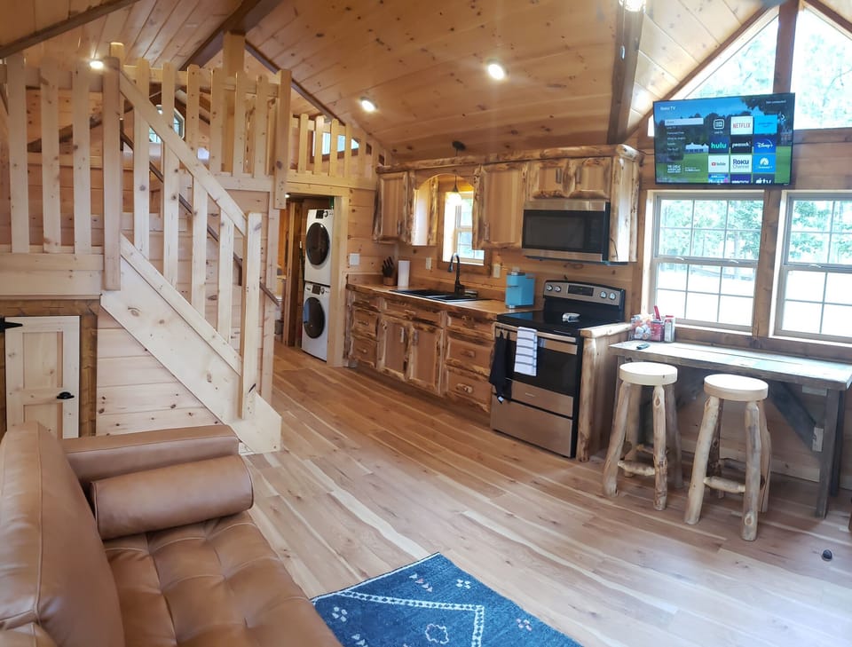 Kitchen/living/dining area of Tiny Toledo. Roku tv above the dinner table.