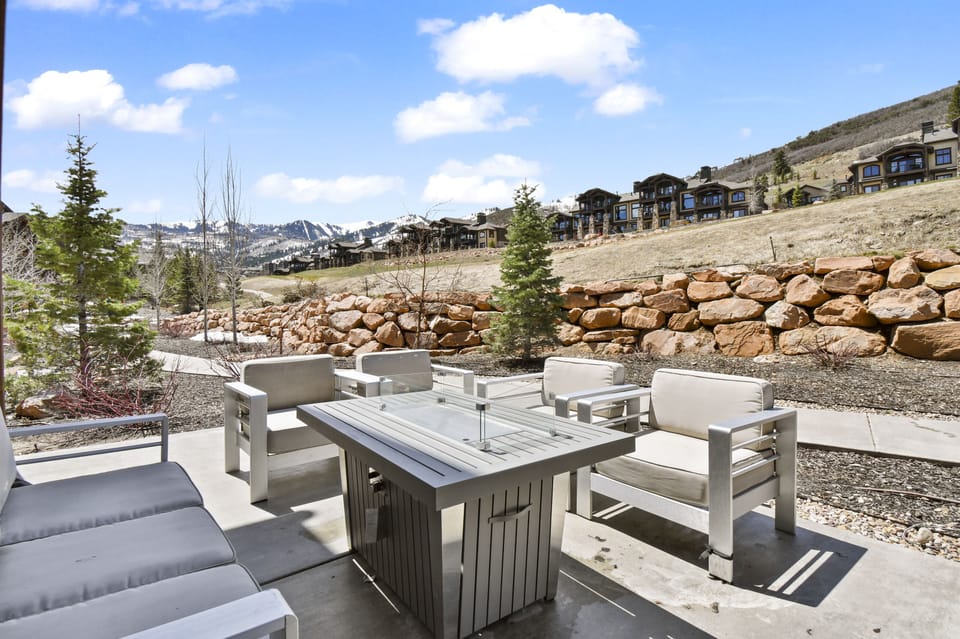 Patio with fire table and comfortable outdoor furnishings.