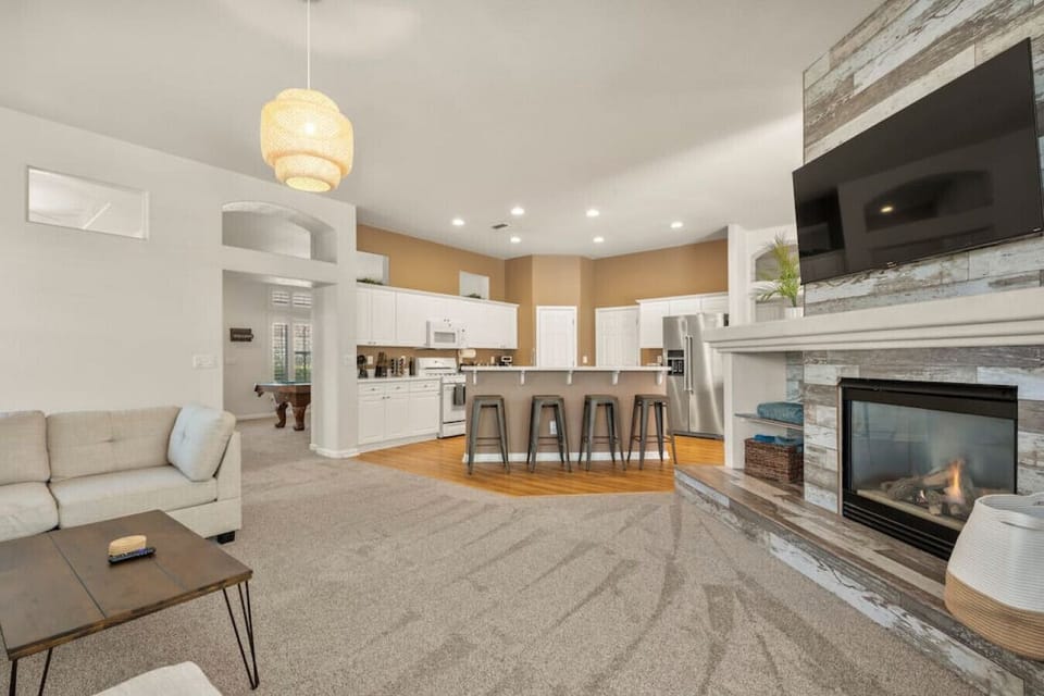 Lounge in our open concept living room with a fireplace and Roku Smart TV. We have free Netflix, HBO Max, and Hulu included!