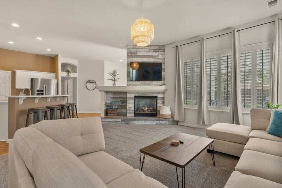 Lounge in our open concept living room with a fireplace and Roku Smart TV. We have free Netflix, HBO Max, and Hulu included!