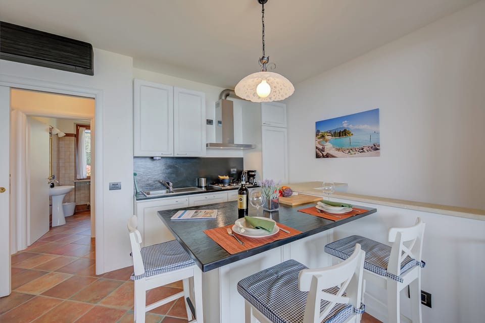 Family Apartment, 2 Bedrooms, 2 Bathrooms, Mountainside (Borgo Belvedere-lake view & shared) | Private kitchen | Highchair