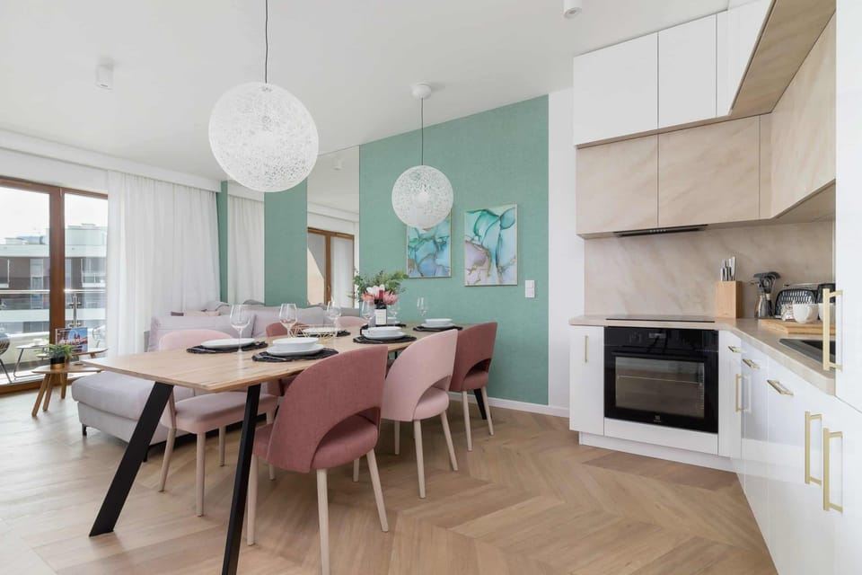 Living room with sofa bed, TV and dining area with fully equipped kitchenette.