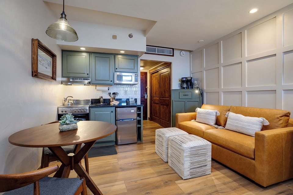 Unwind in your stylish open-plan retreat with cozy sofa, dining nook, and full kitchen ready for your culinary adventures.
