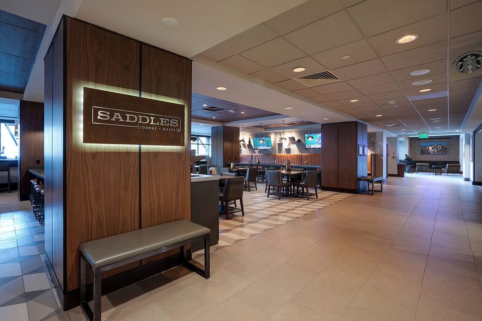 Unwind in this sophisticated lounge featuring rich wood accents, comfortable seating, and multiple screens for your entertainment and relaxation.