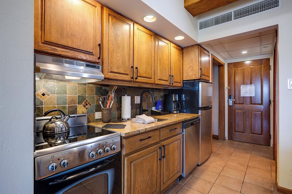 Your fully-equipped kitchen features warm wood cabinetry, granite counters, and stainless appliances for all your culinary adventures.