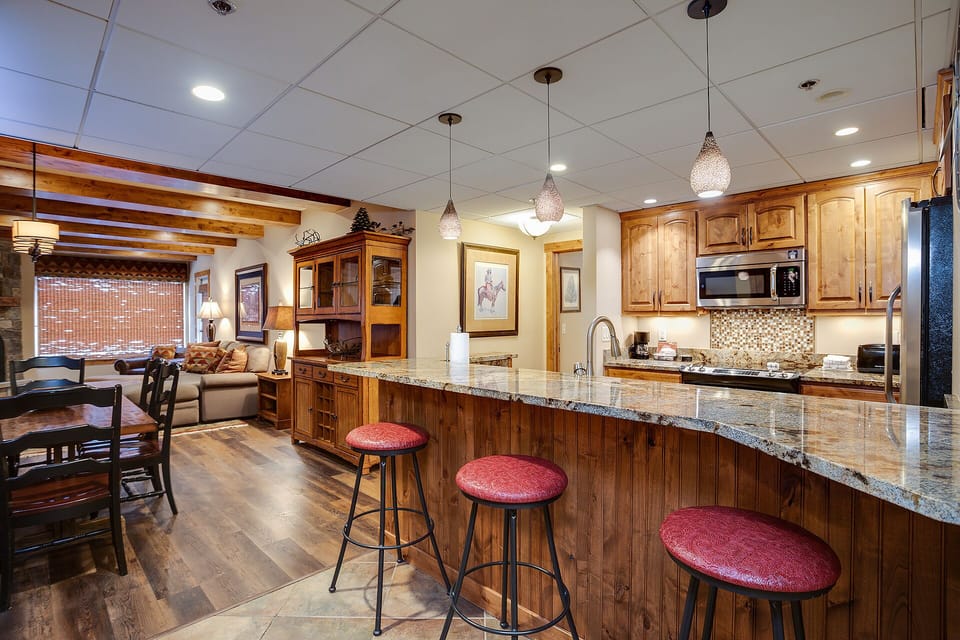 Your gourmet kitchen features granite counters, premium appliances, and a breakfast bar perfect for morning coffee or evening conversations.