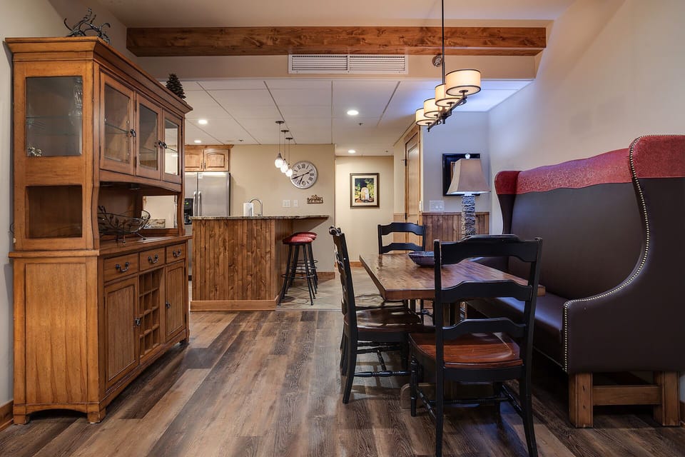 Gather around your elegant dining table and enjoy meals in this beautifully appointed space with rustic wood beams overhead.