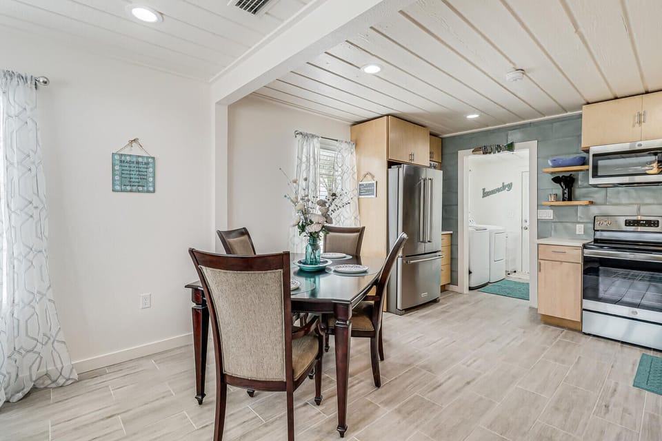 You'll love gathering around this elegant dining table in your beautifully appointed open-plan space, where modern kitchen amenities await your culinary adventures.