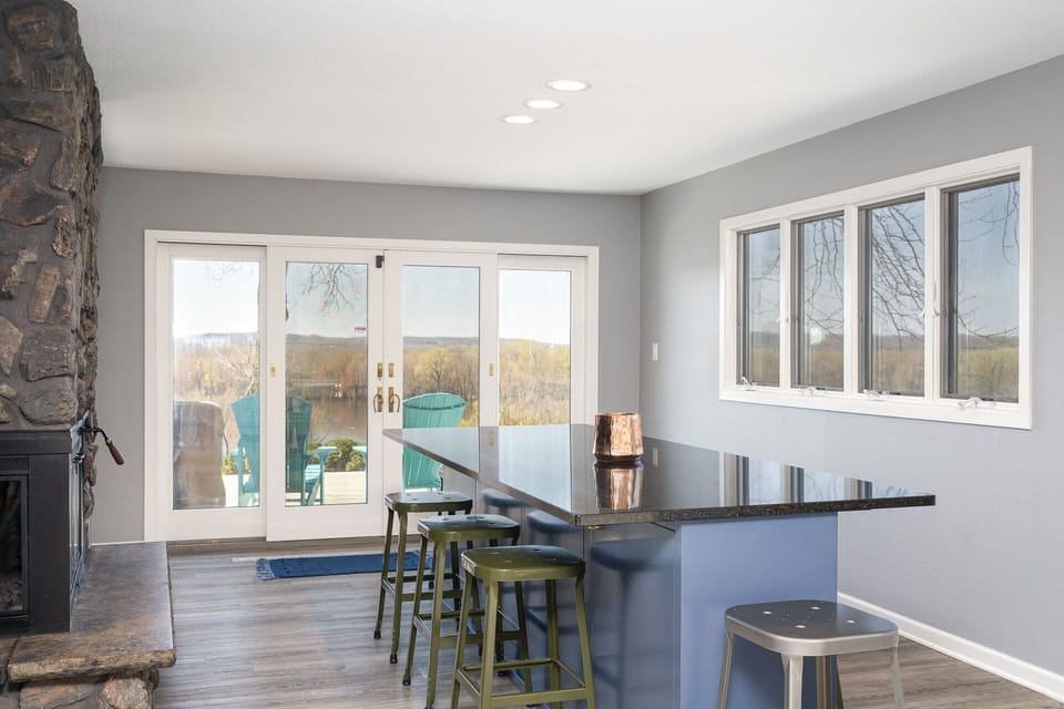 Your stylish bar area opens to a lakeside patio through elegant French doors, perfect for morning coffee or evening cocktails.